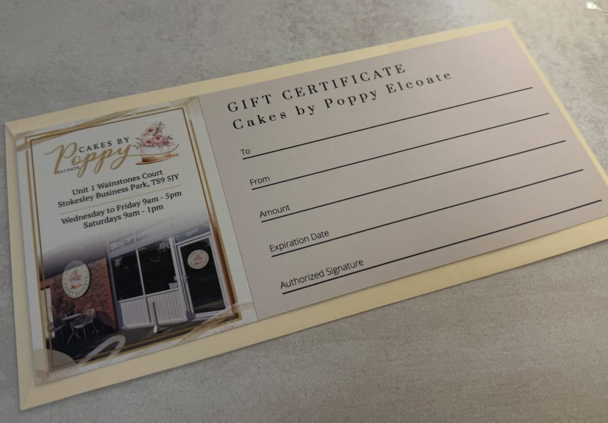 A printed Cakes by Poppy Elcoate gift certificate resting on a cream envelope