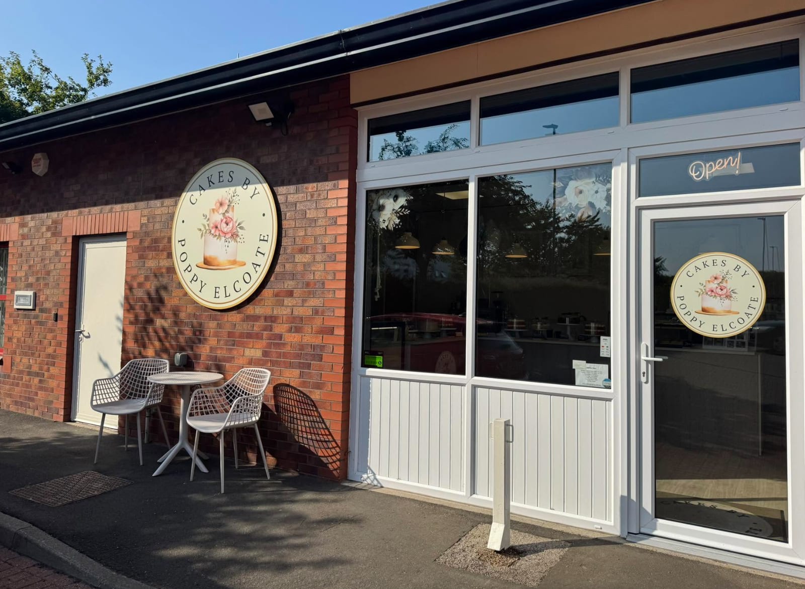 The Cakes by Poppy Elcoate shop on Stokesley Business Park, with its round logo sign and outdoor table